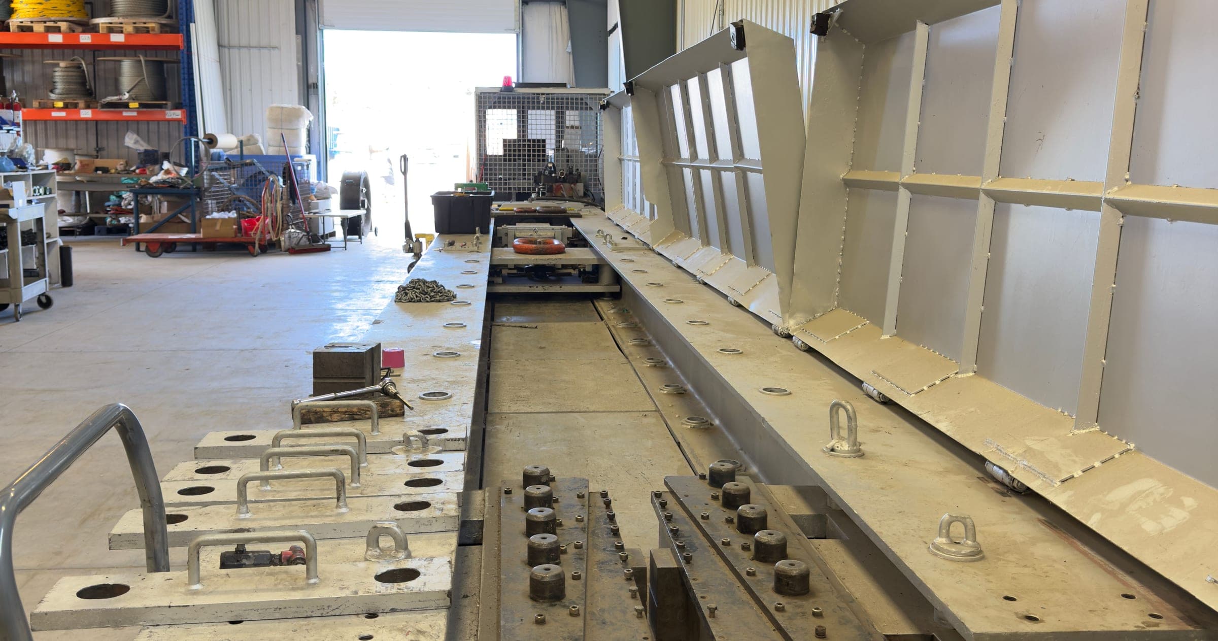The horizontal test bed running the length of the bay, anchor points along its rails