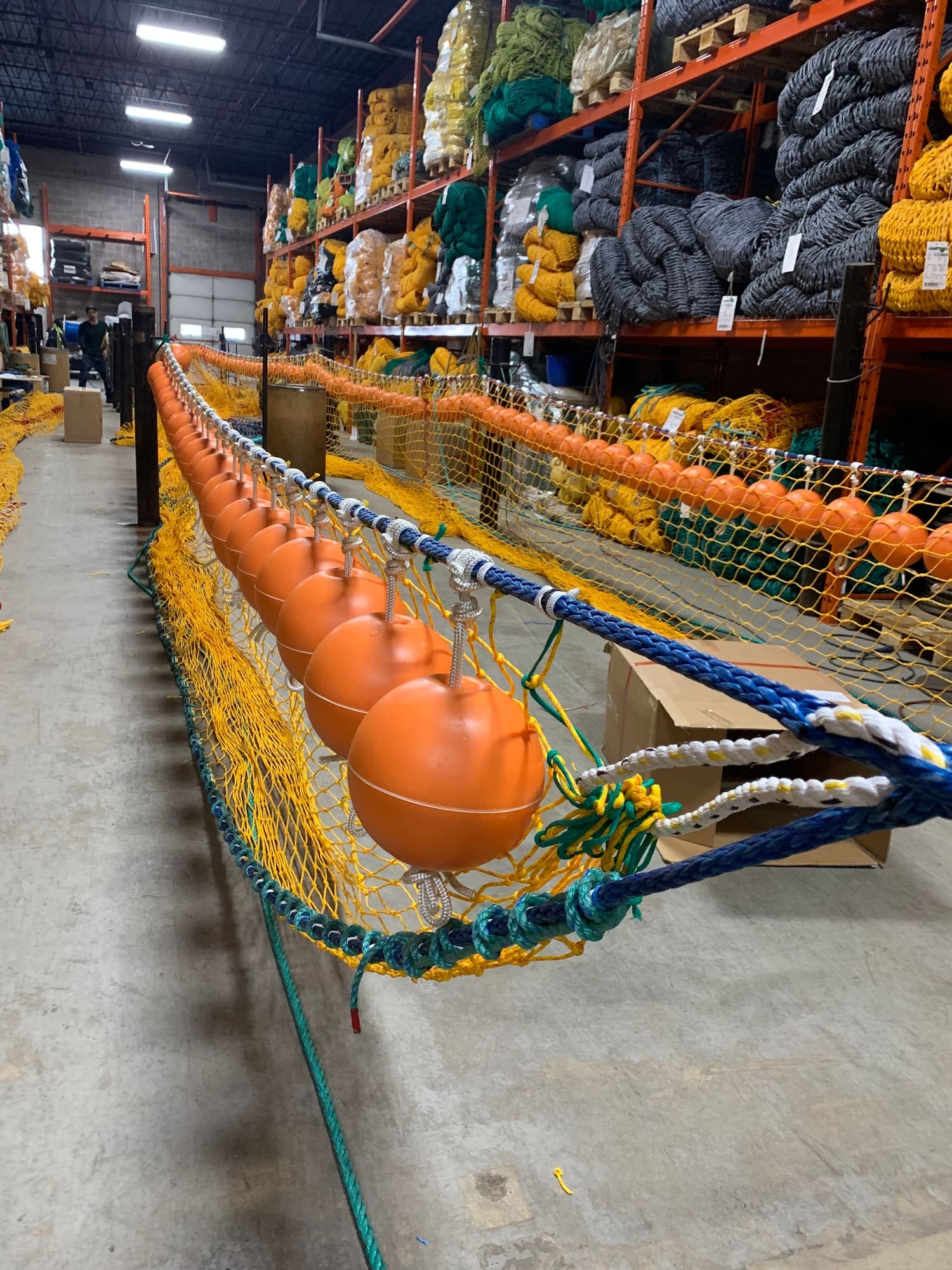 A headline hung with orange floats running the length of the net loft